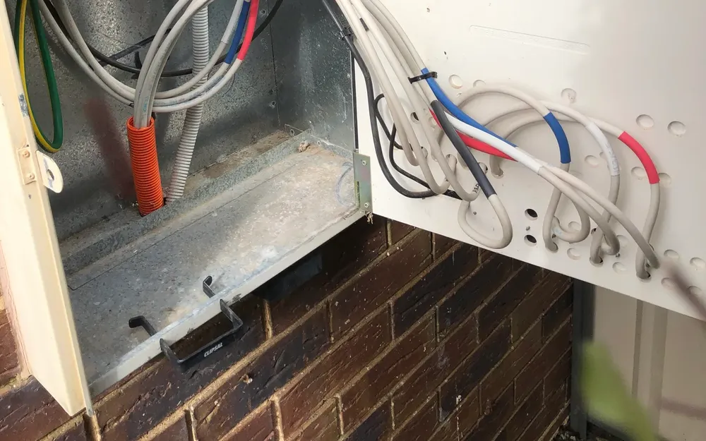 Switchboard upgrade in progress on the outside wall of a home